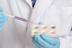 A lab worker tests a sample for employee drug testing.